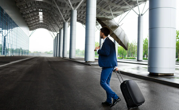 Man moving with his luggage to the airport