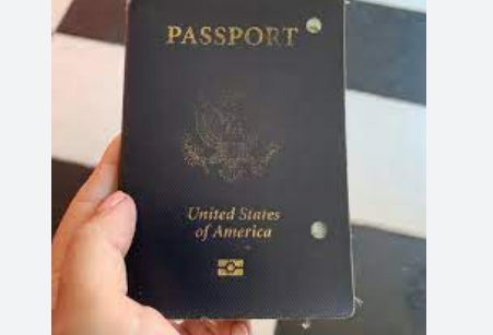 A handheld old passport that should match a birth certificate