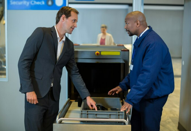 Security personel checking an unattended luggage