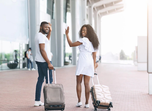 African couples saying goodbye to someone who dropped them at the airport