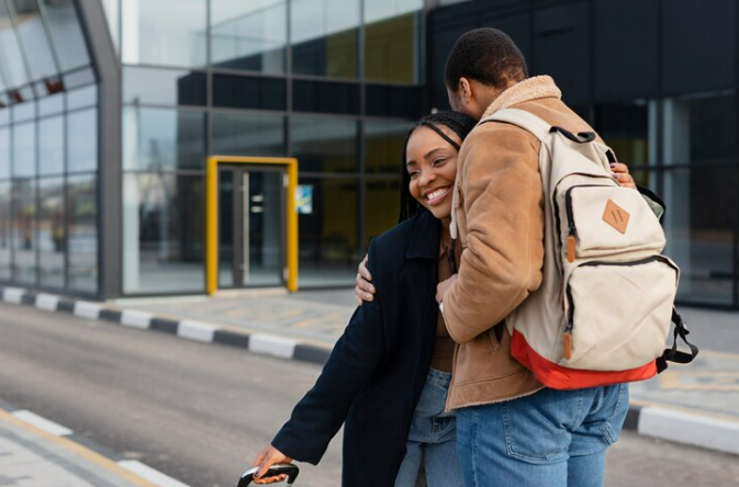 Man giving his wife a warm hug before picking her up from the airport